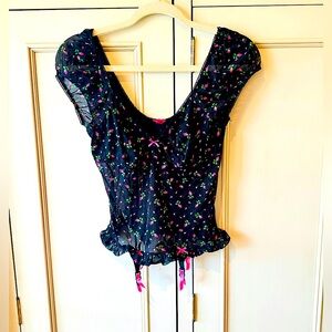 Betsey Johnson Top. Black lace with pink roses. There are little garter buckles.